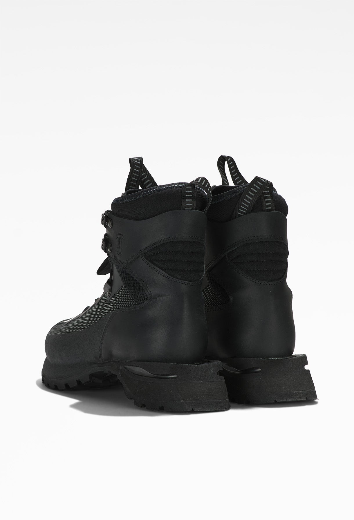 Black hiking boot with rugged design, sturdy laces, metal eyelets, and thick, treaded sole.