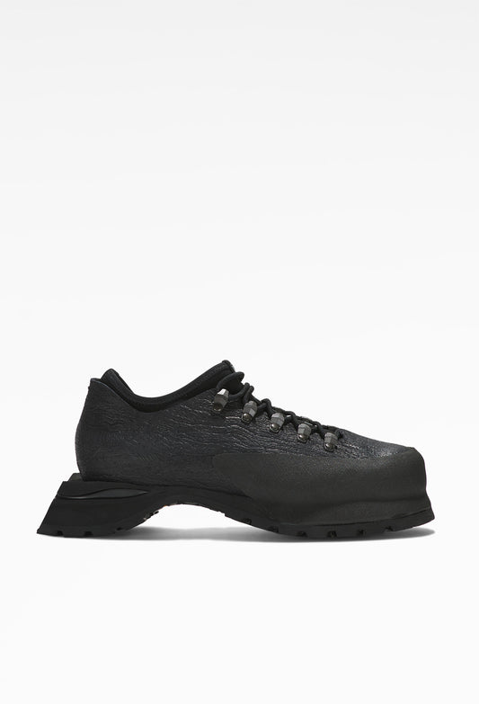 Black hiking boots with sturdy soles, intricate lacing, rugged design, mesh fabric sides, and metal eyelets.