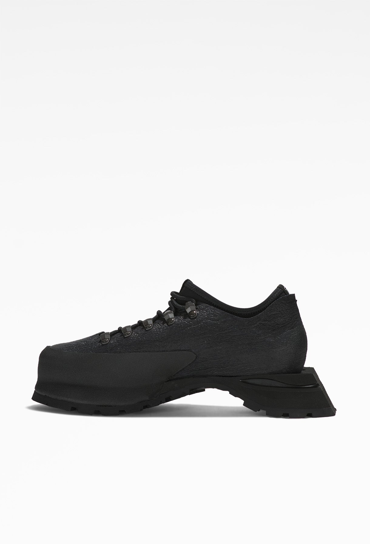 Black hiking boots with sturdy soles, intricate lacing, rugged design, mesh fabric sides, and metal eyelets.